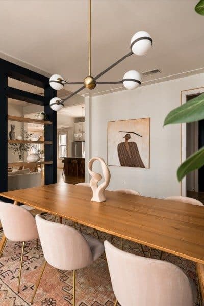 Dining room with a long wood table and a modern chandelier at 2020 10th Avenue South, 12 South Nashville