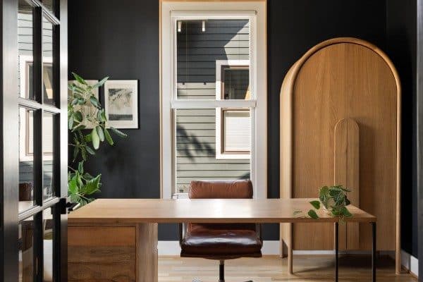 Office with a built-in desk and a dark accent wall at 2020 10th Avenue South, 12 South Nashville