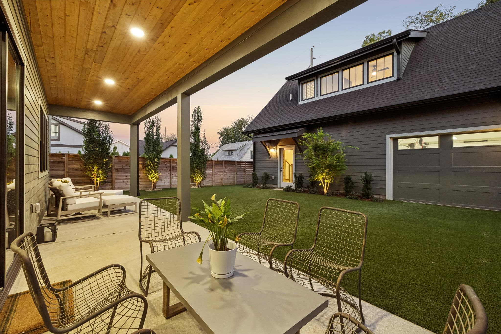 Covered outdoor patio and yard at dusk at 1101 Montrose Avenue in Montrose Place, 12 South Nashville