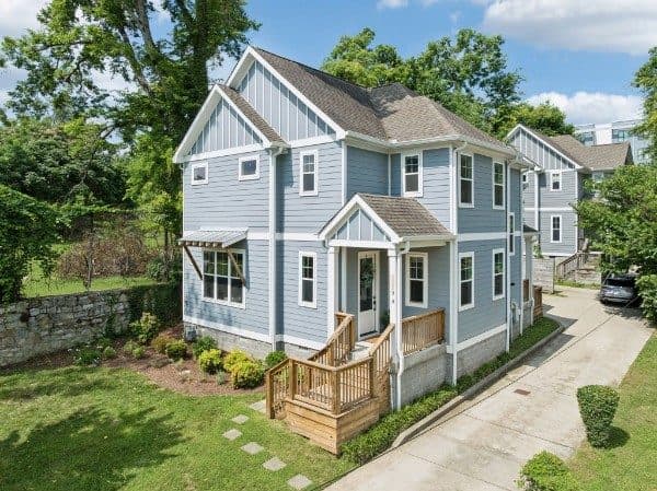 Front exterior of the blue-gray two-story home with white trim and wood front steps at 2229A 11th Avenue South, one of the 12 South homes for sale in 12 South Nashville
