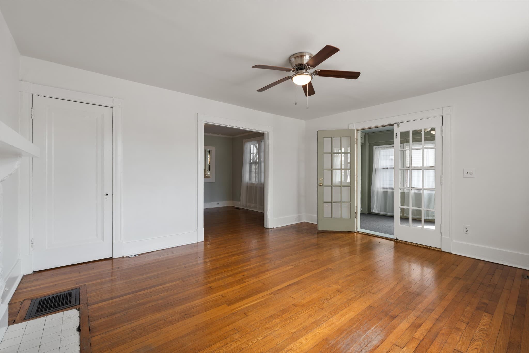 Living room with hardwood floors and French doors at 1202 Ashwood Ave in 12 South Nashville