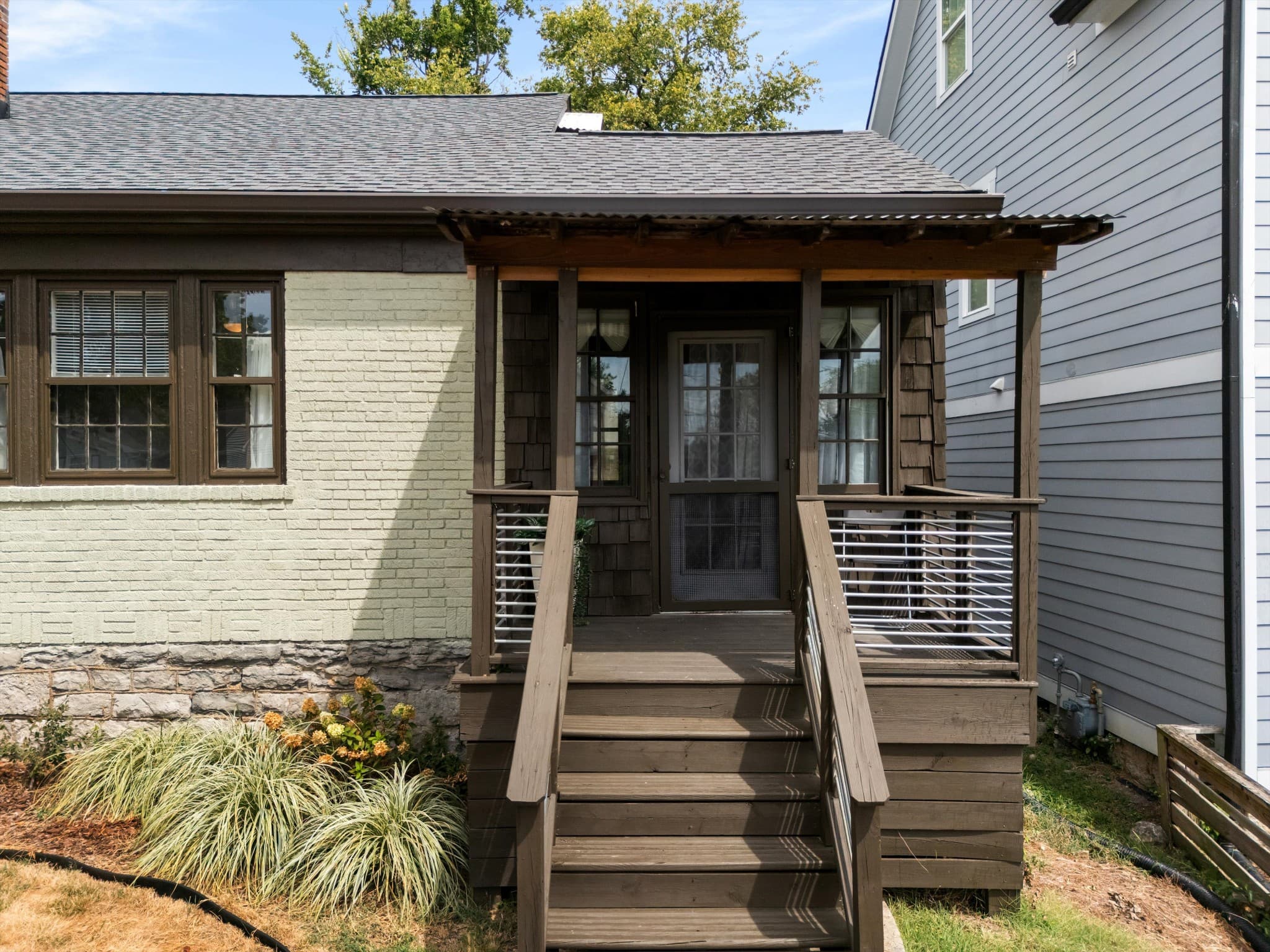 Covered front porch and wood steps at 1202 Ashwood Ave in 12 South Nashville