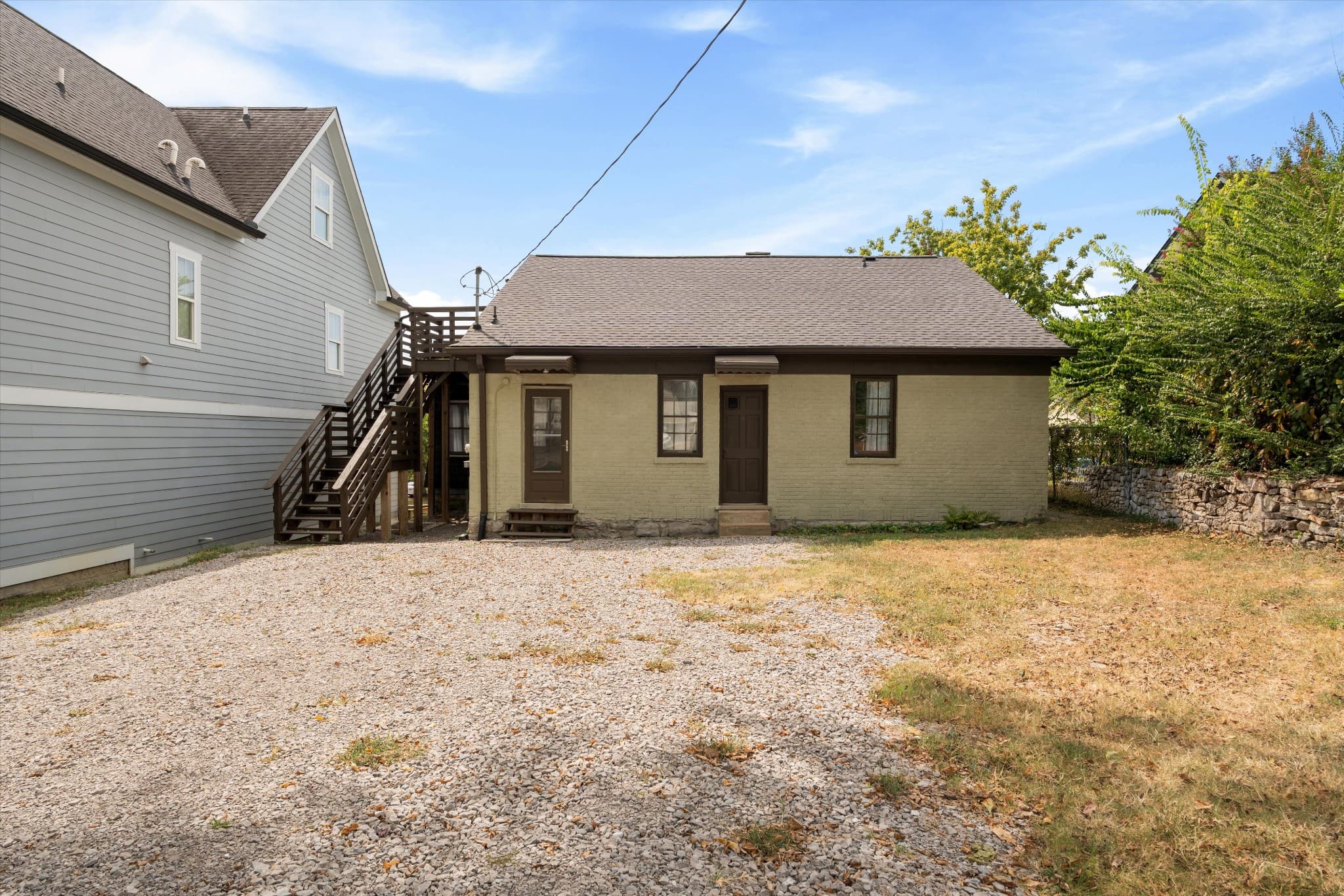 Back of 1202 Ashwood Ave with gravel parking off the alley in 12 South Nashville