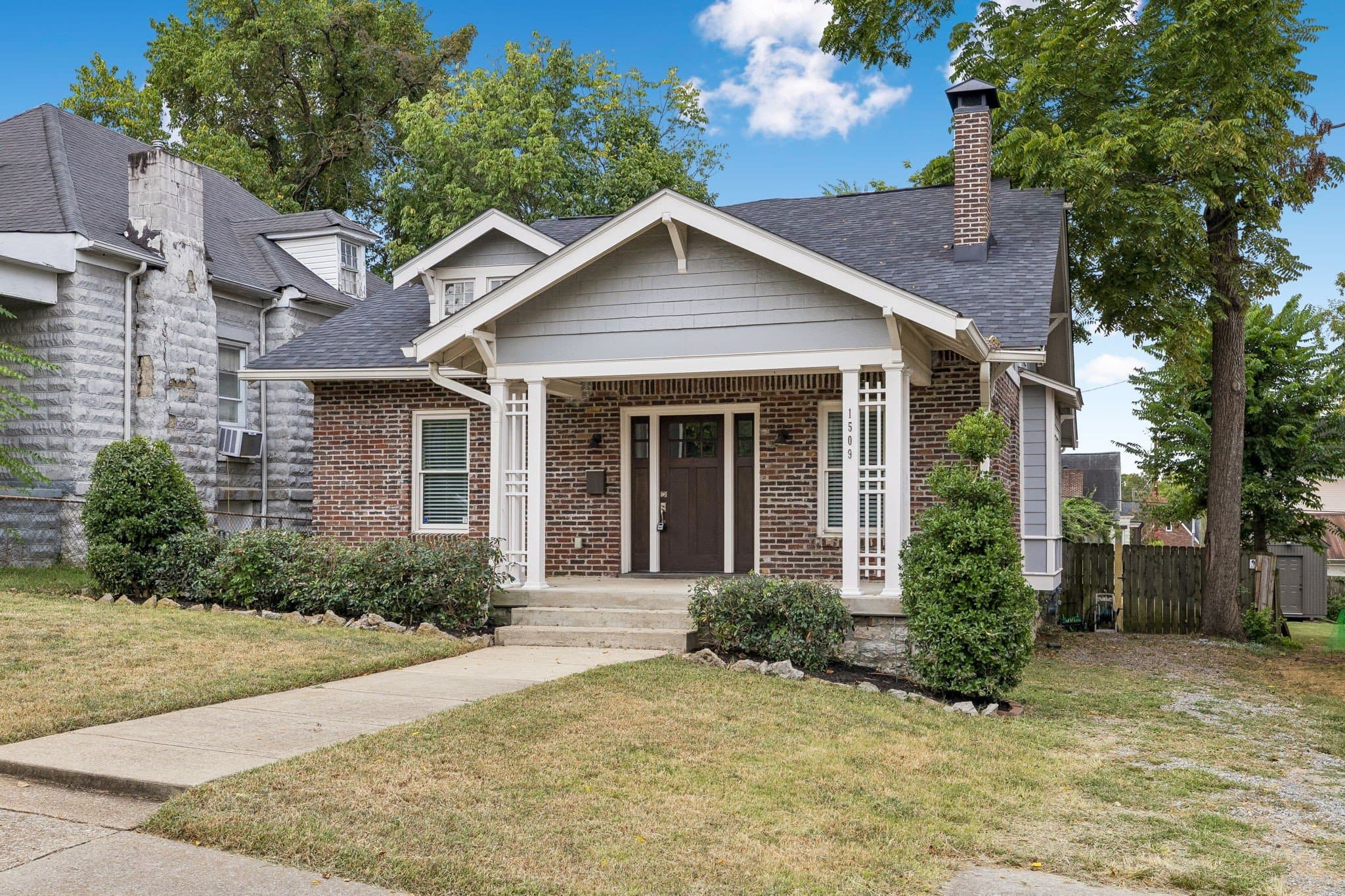 Front exterior of the brick bungalow with house number 1509 at 1509 Ashwood Avenue, one of the 12 South homes for sale near Belmont in Nashville