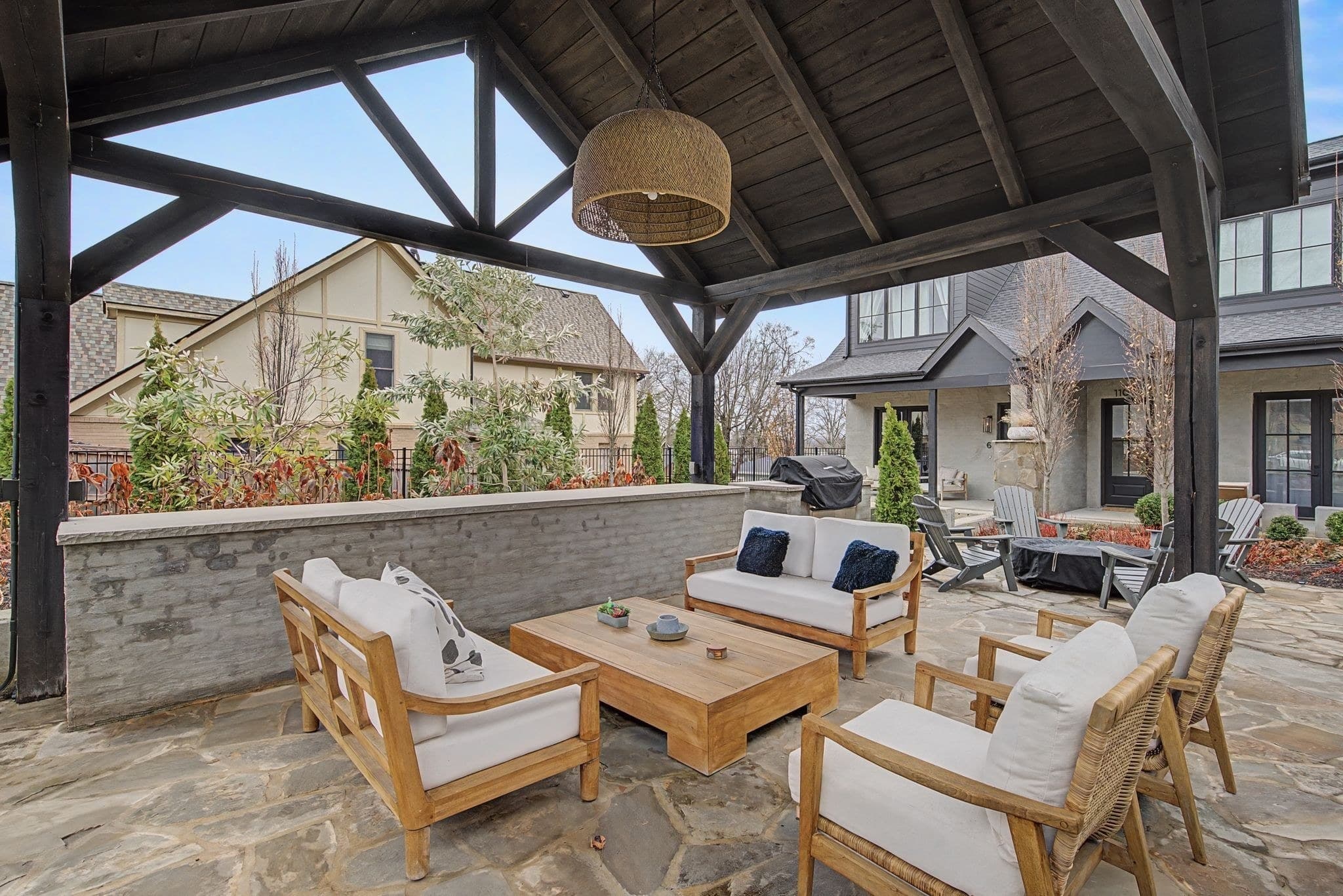 Community garden pavilion with lounge seating on flagstone, a fire pit with chairs beyond, and a gas grill in the shared outdoor space for 2086 12th Avenue South in 12 South Nashville