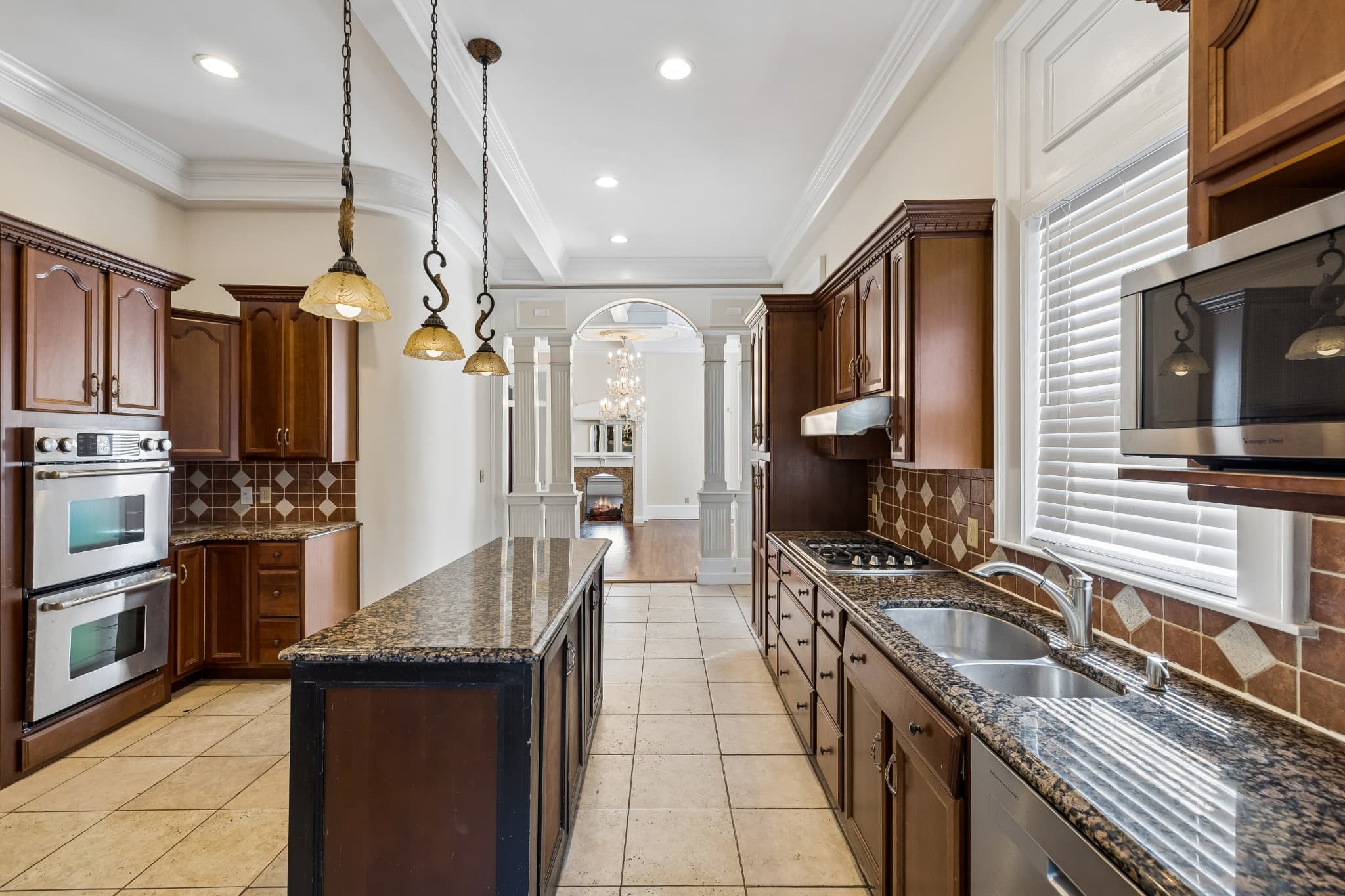 Kitchen with wood cabinets, granite counters, double wall ovens, a gas cooktop and a center island at 2107 10th Avenue South in 12 South Nashville