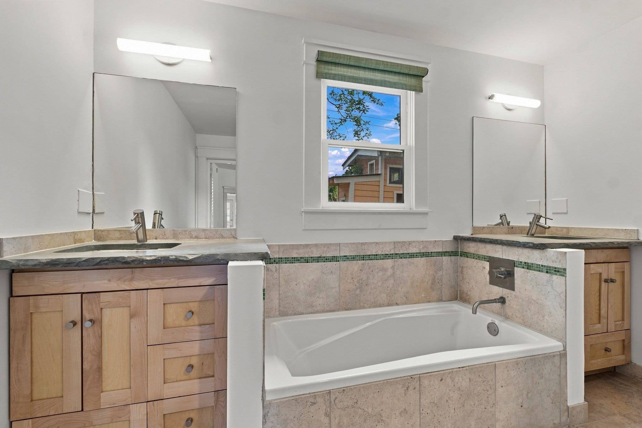 Main level primary bath with two vanities and a soaking tub at 2112 15th Ave S in 12 South Nashville