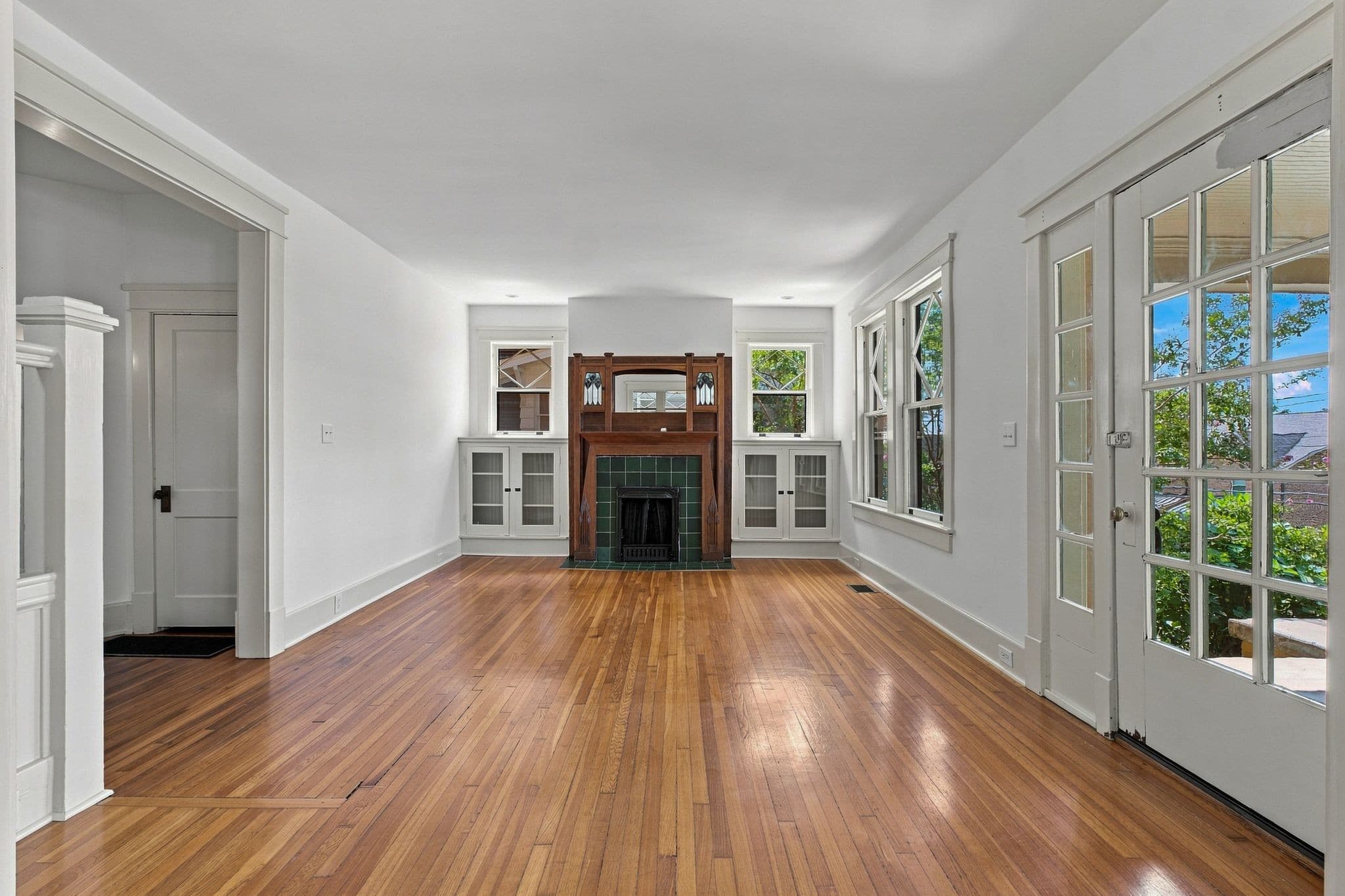Living room with hardwood floors and a fireplace with an antique mantel at 2112 15th Ave S in 12 South Nashville