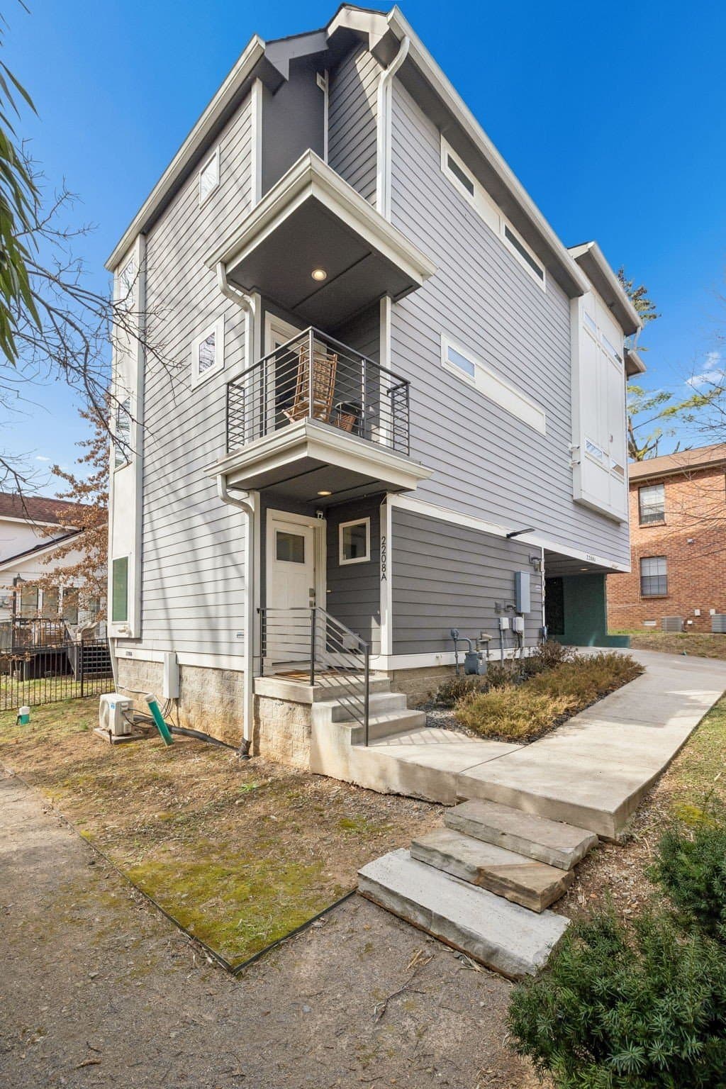 Front exterior of 2208 Elliott Ave #A, a three story contemporary home with balconies set back from Elliott Ave, one of the 12 South homes for sale in Nashville