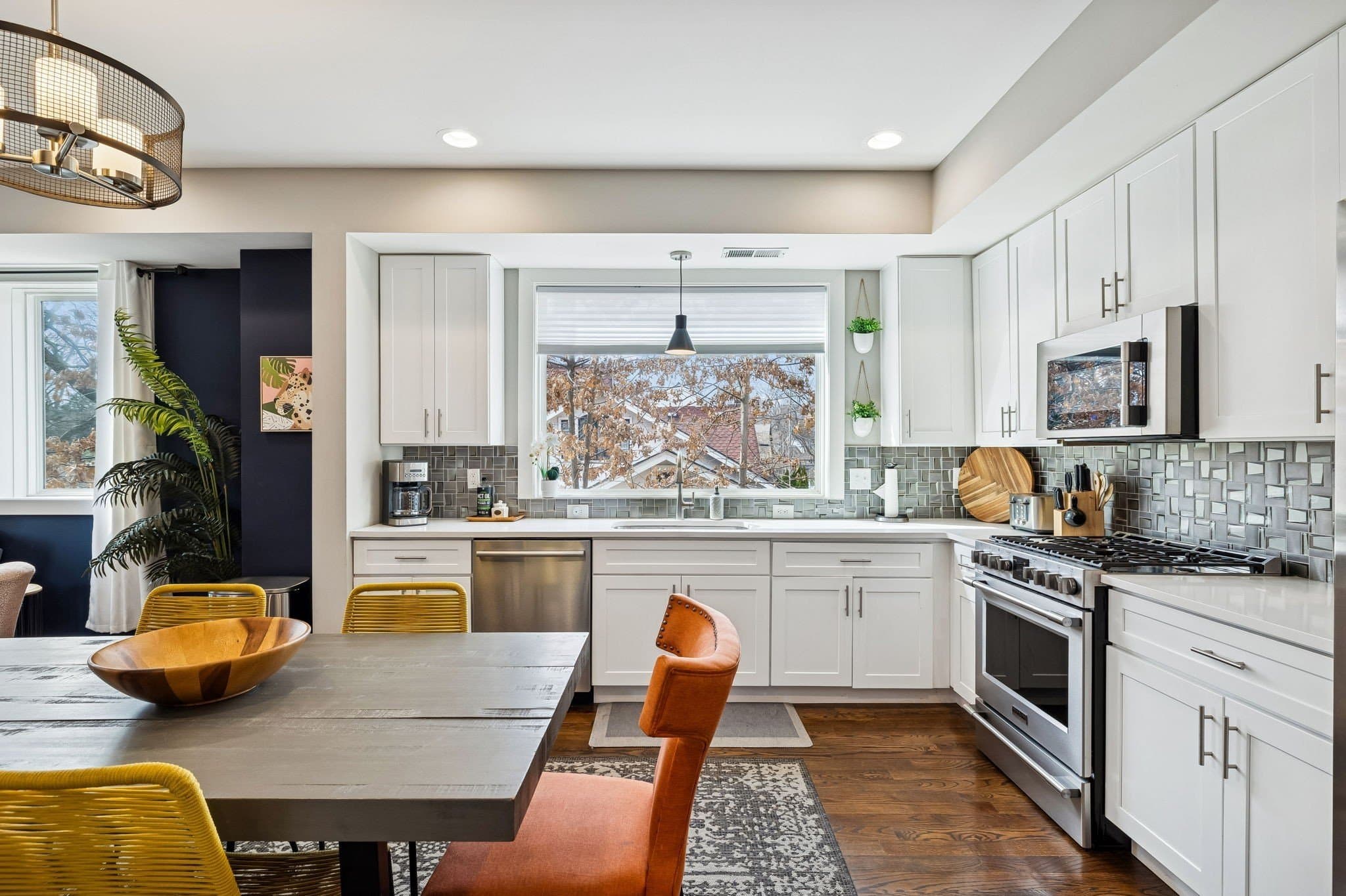 Kitchen with white cabinets, stainless appliances, a gas cooktop, and eat in dining at 2208 Elliott Ave #A in 12 South Nashville