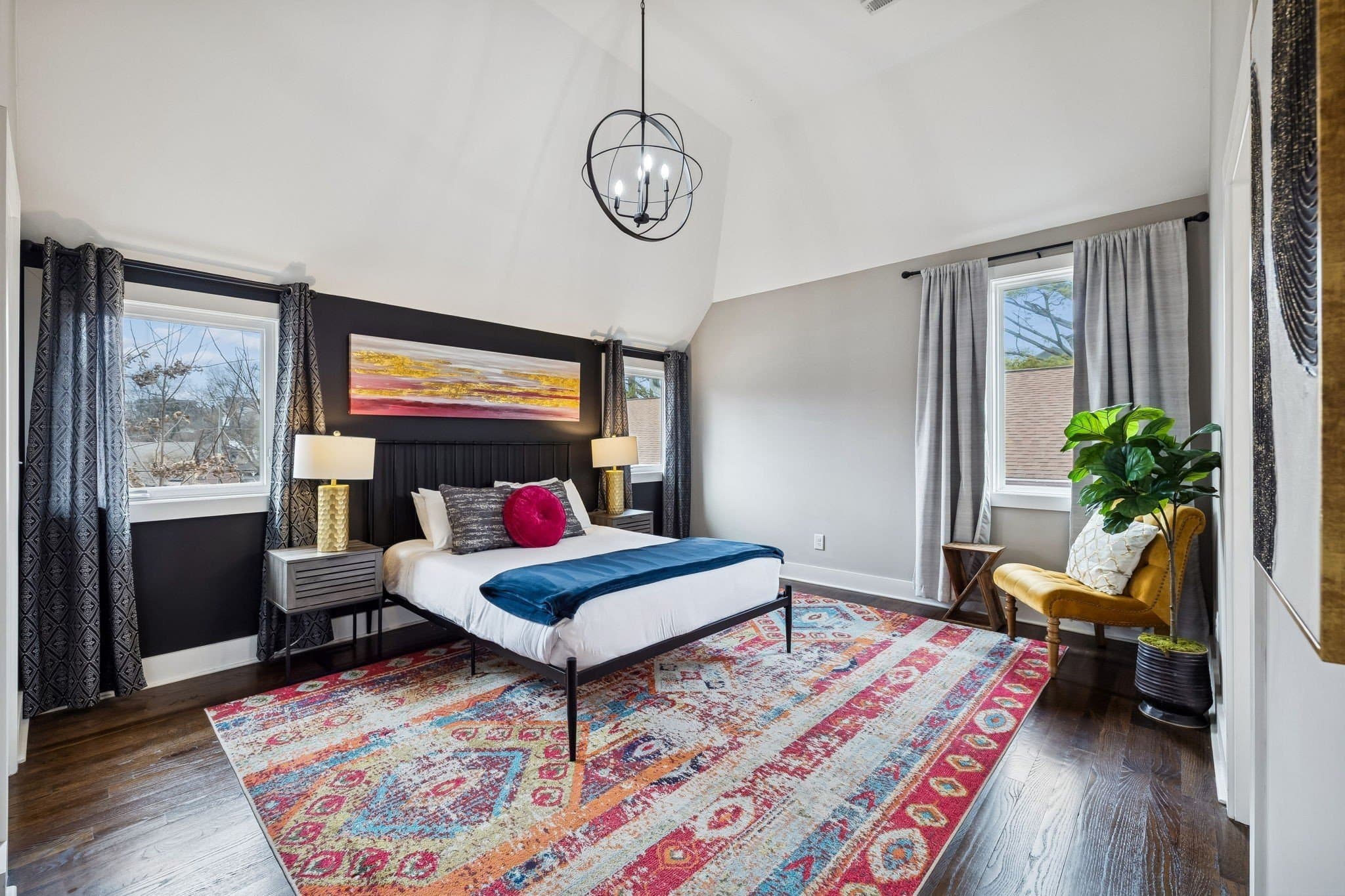Bedroom suite with a vaulted ceiling, hardwood floors, and a pendant light at 2208 Elliott Ave #A in 12 South Nashville
