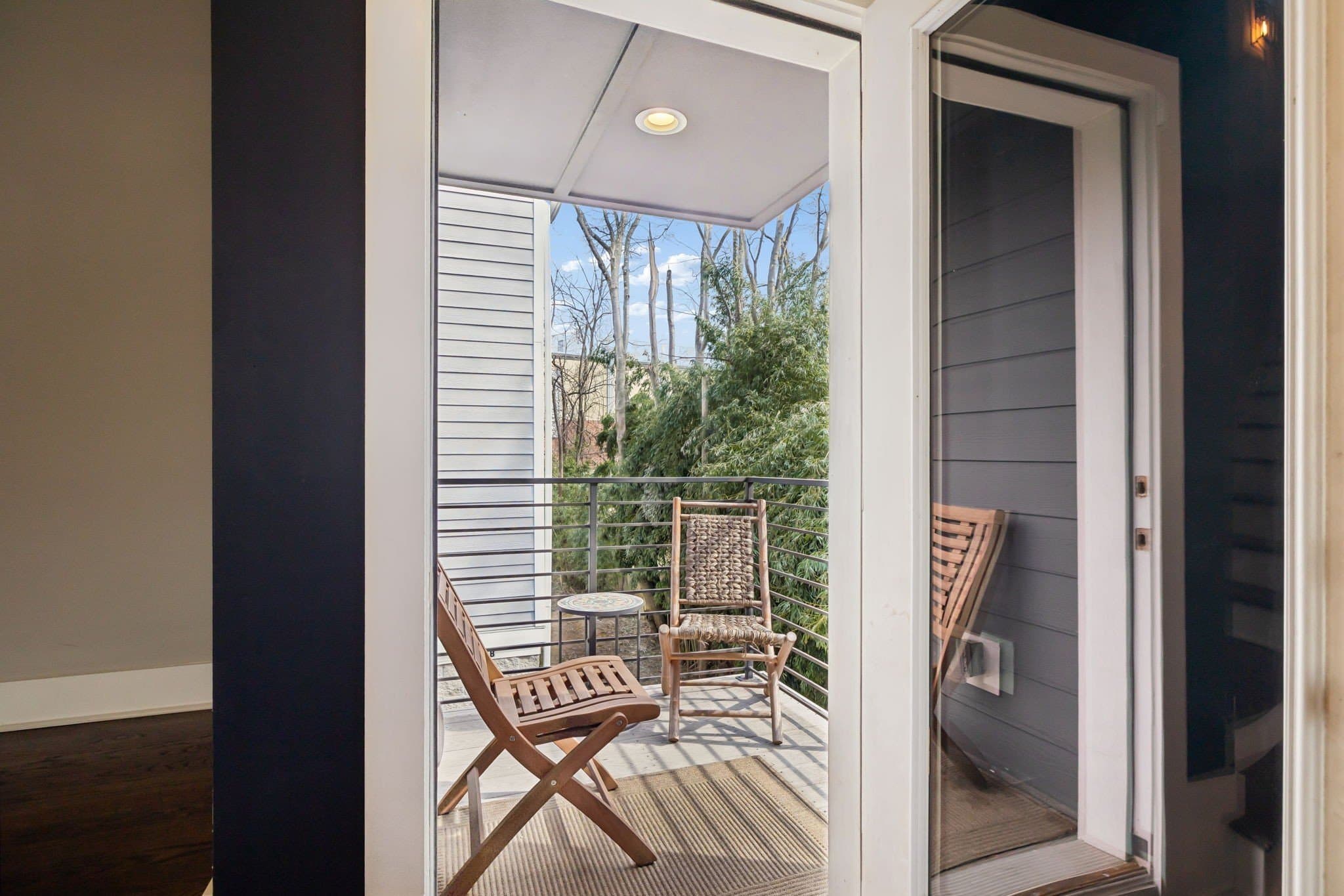 Private covered deck with two chairs off the upper level at 2208 Elliott Ave #A in 12 South Nashville