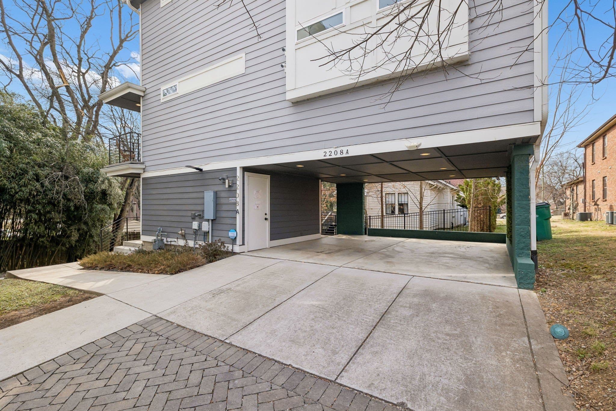 Side exterior with the covered carport and paved drive at 2208 Elliott Ave #A in 12 South Nashville