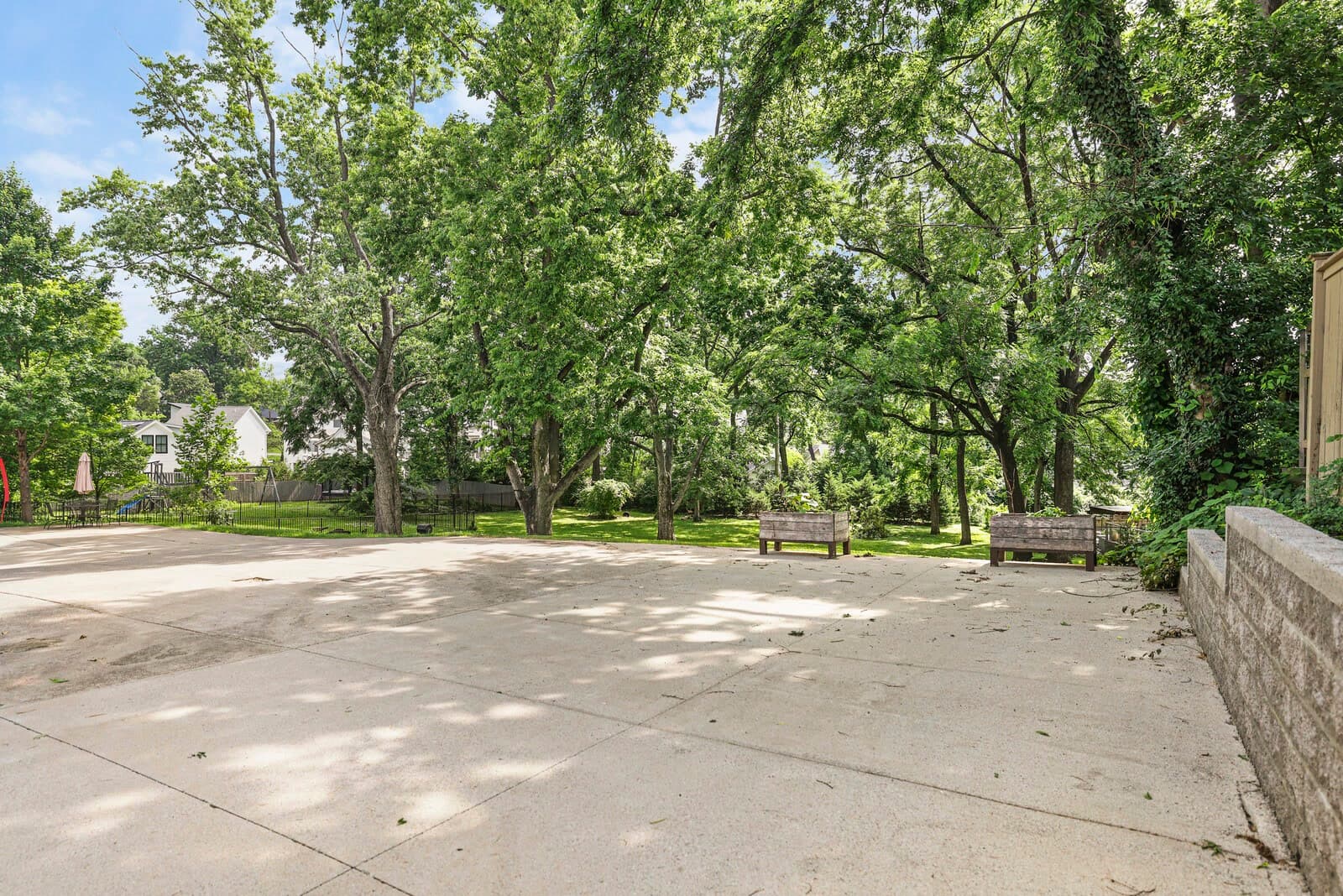 Shared back yard green space with mature trees and a concrete parking pad behind 2500B 9th Ave S in 12 South Nashville