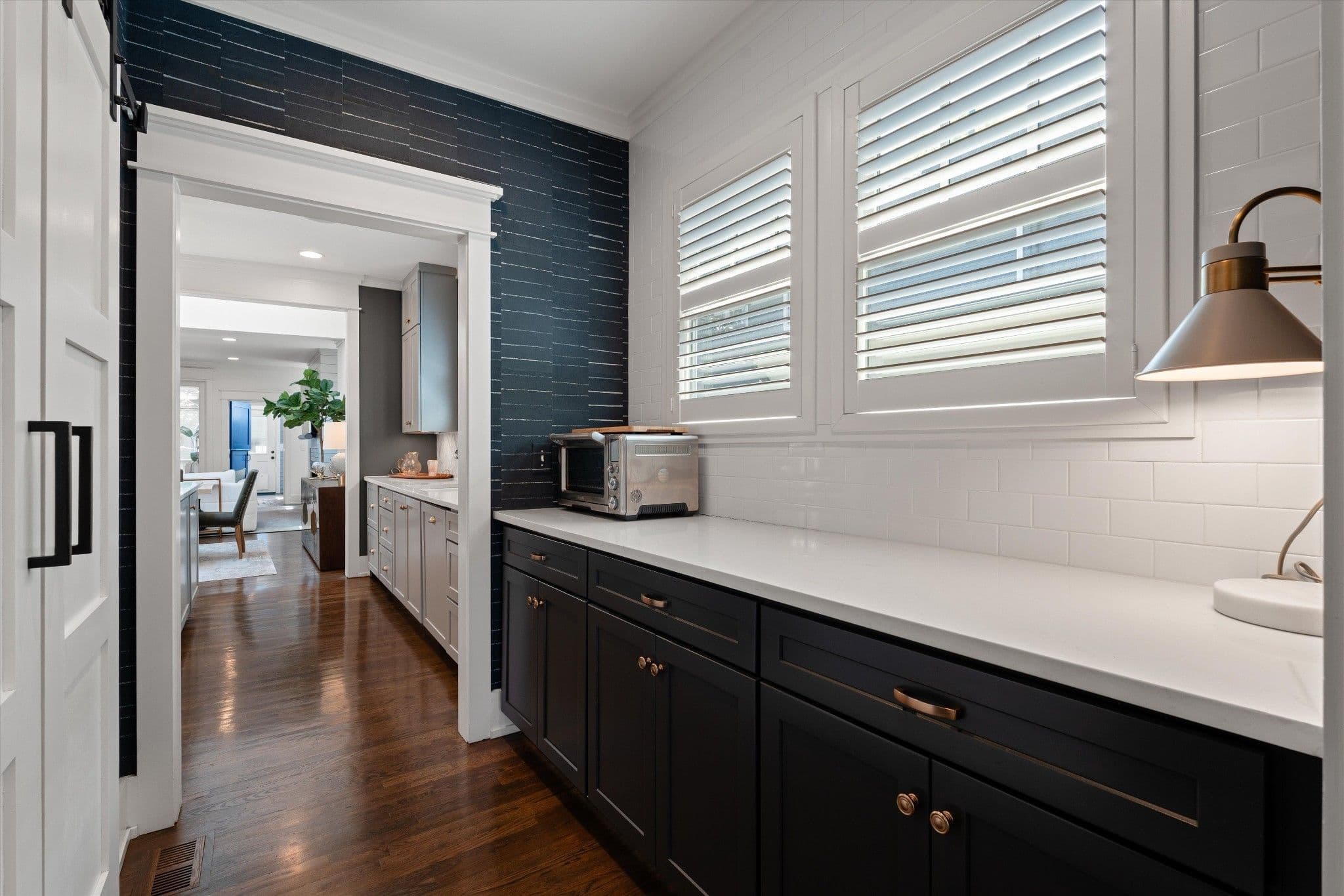 Kitchen with black lower cabinets, white counters and white subway tile at 2510 Belmont Boulevard in 12 South Nashville