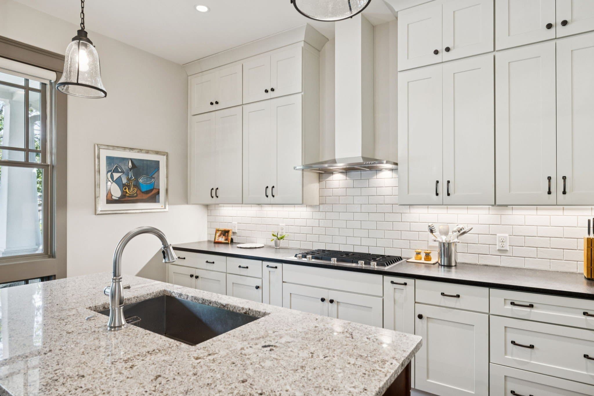 Kitchen with island, white cabinetry and granite counters at 2907 Oakland Avenue near 12 South Nashville