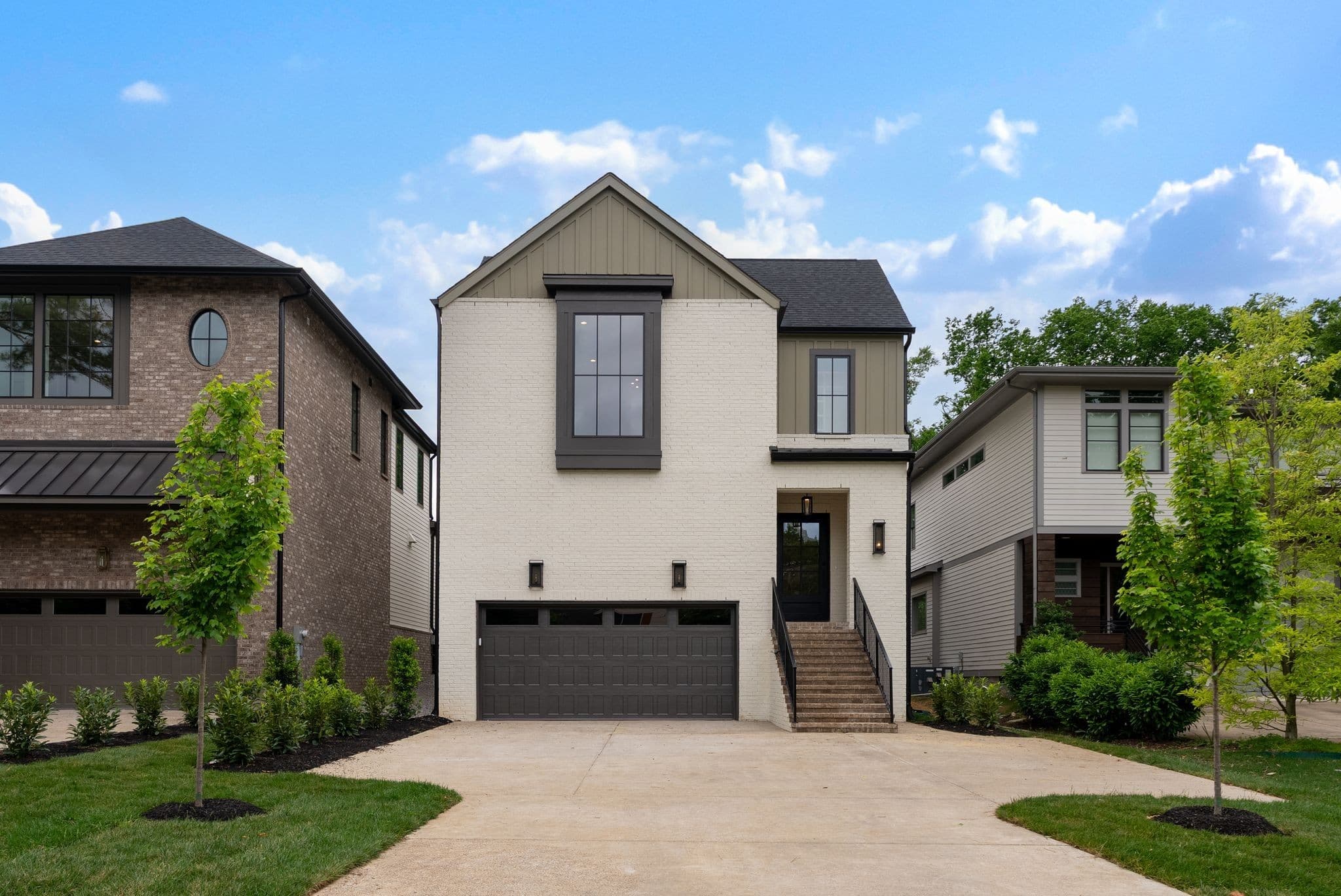Front exterior of 2913 Vaulx Ln, a 2026 two story brick and stucco home with a front entry garage and driveway, one of the 12 South homes for sale in Nashville