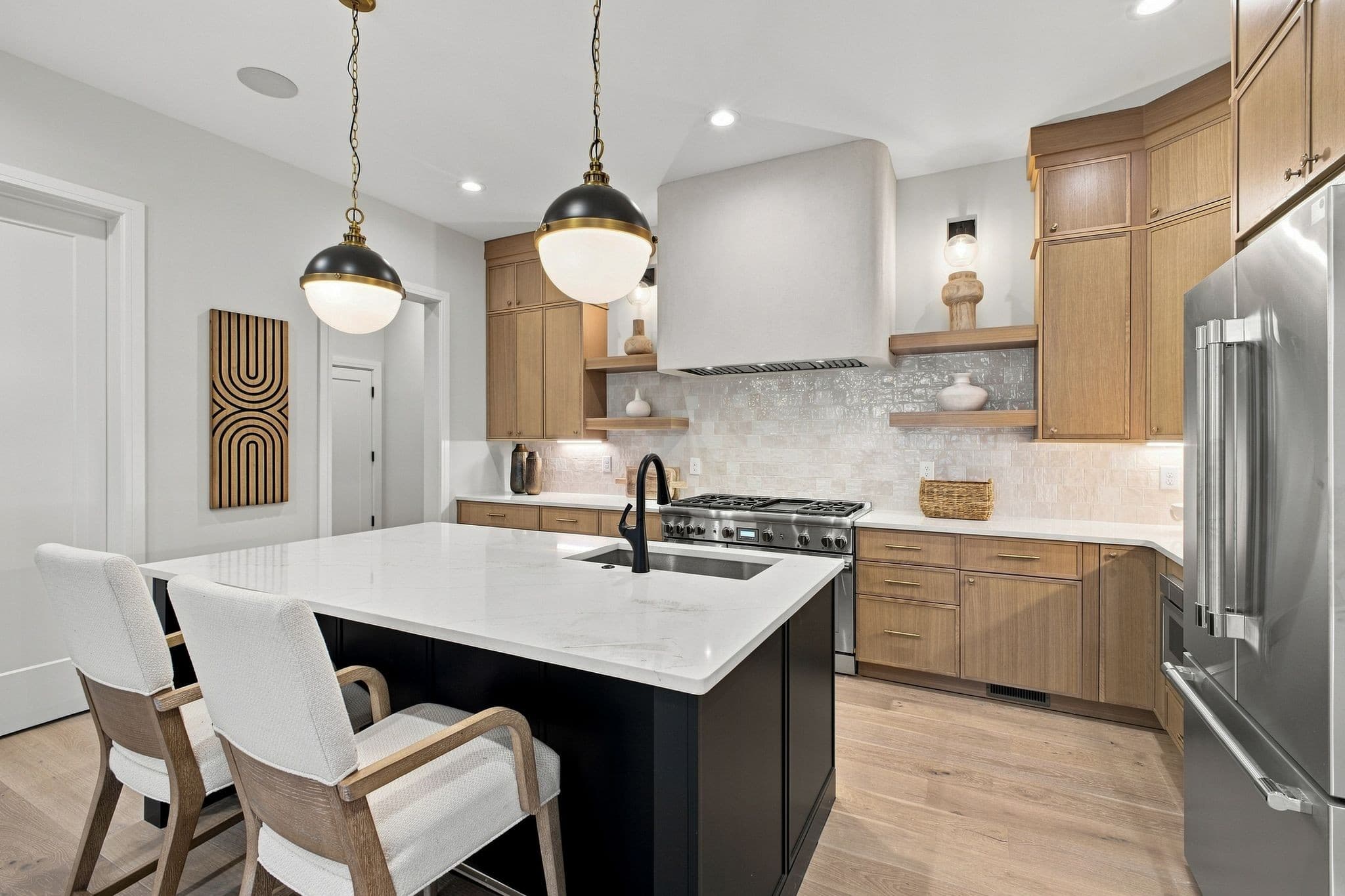 Kitchen with an oversized quartz island, pendant lights, wood cabinetry, and a Thermador range at 2913 Vaulx Ln in 12 South Nashville