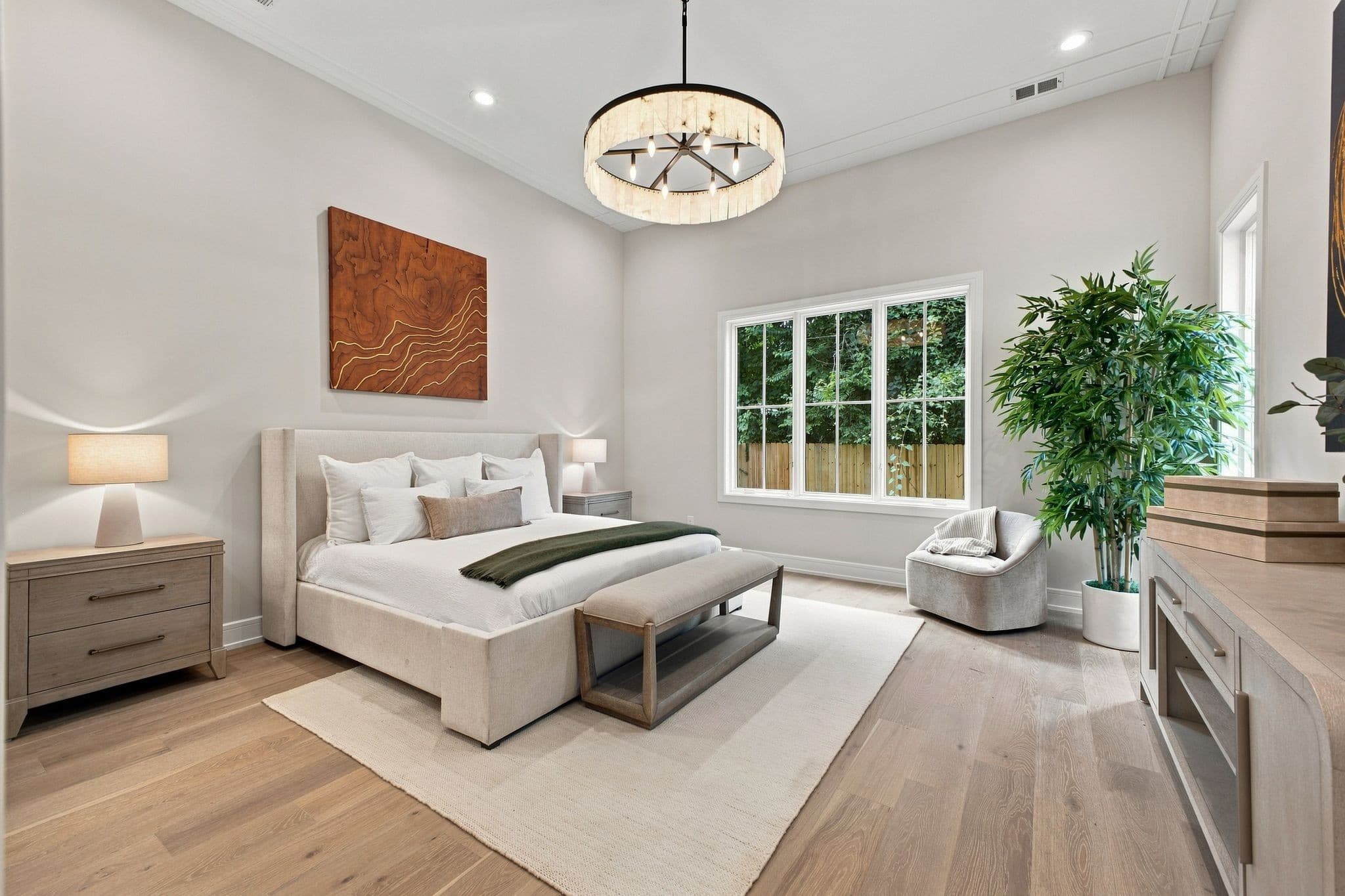 Main level primary bedroom with white oak floors and large windows at 2913 Vaulx Ln in 12 South Nashville