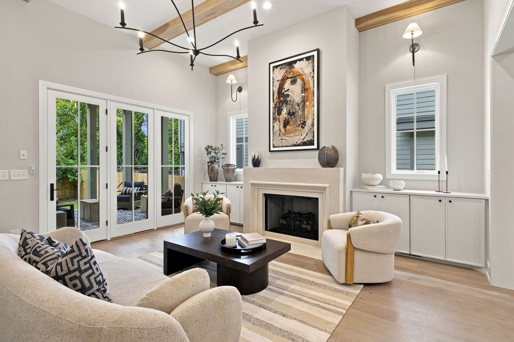 Living room with a gas fireplace, custom built ins, and glass doors to the back porch at 2913 Vaulx Ln in 12 South Nashville
