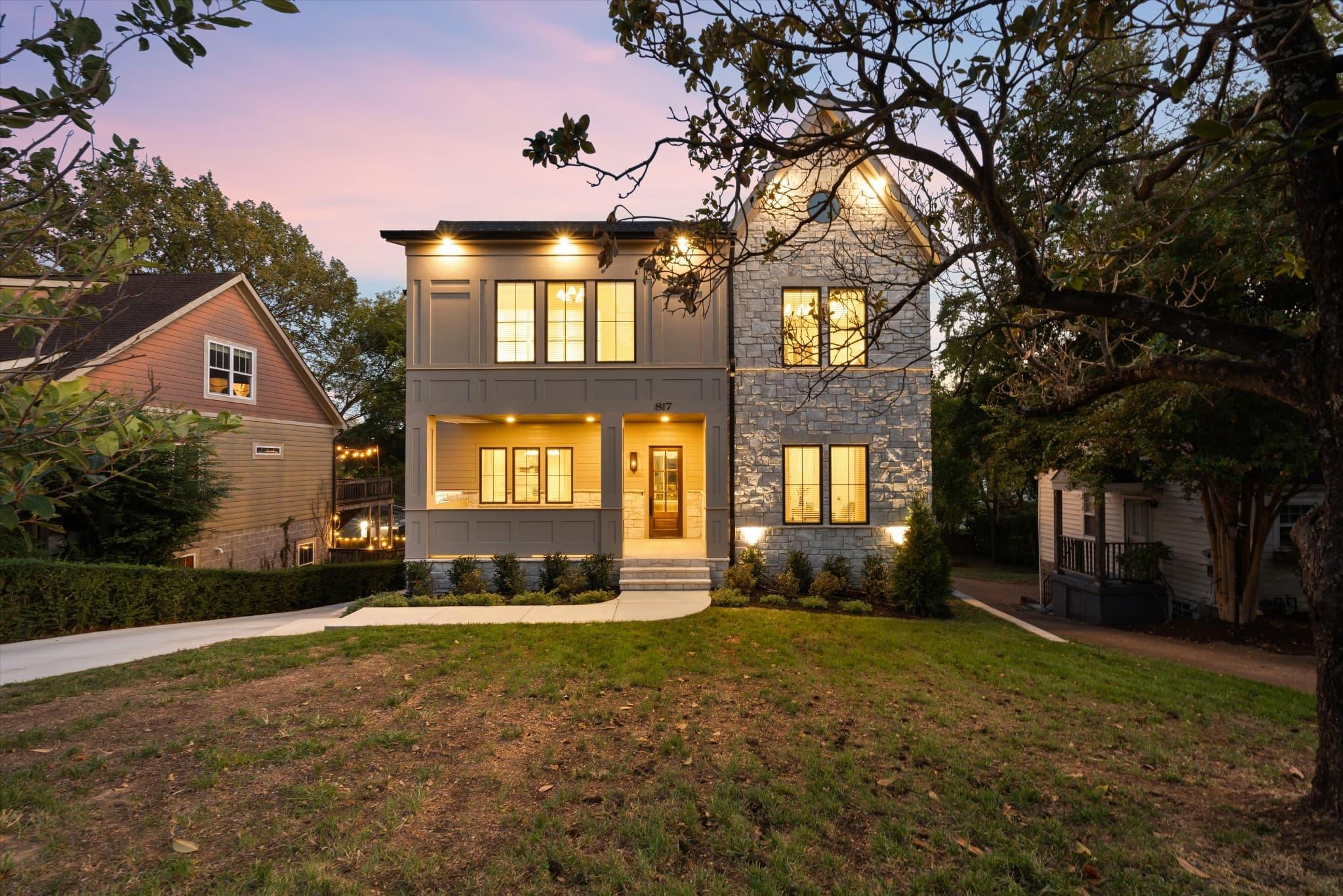 Front exterior of 817 Horner Ave at twilight, a 2026 two story home with brick, stone, and fiber cement, one of the 12 South homes for sale in Nashville