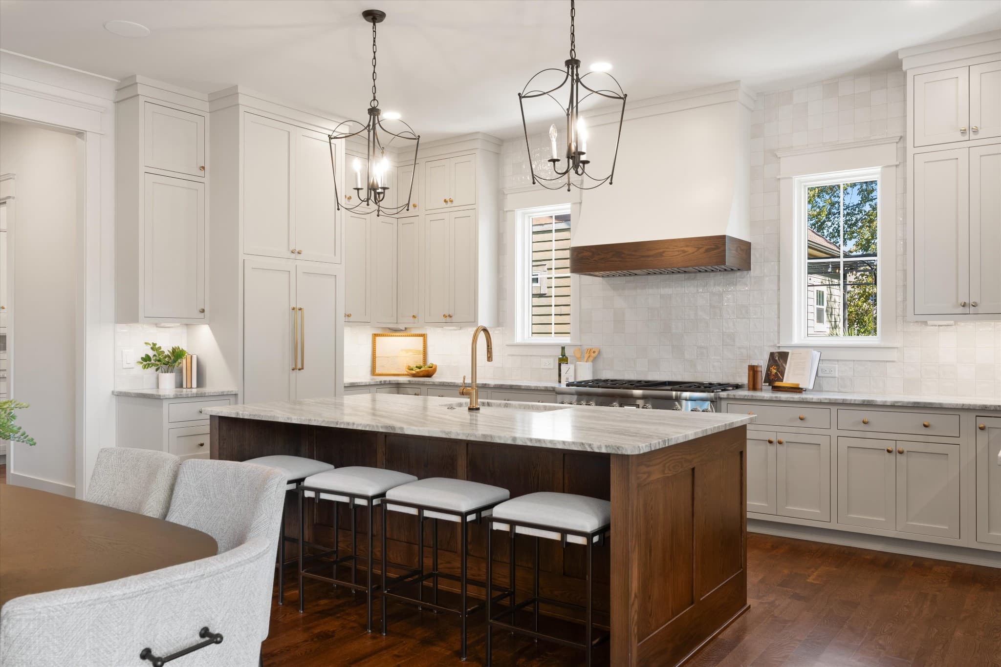 Kitchen with white cabinetry, an oversized island with seating, and pendant lights at 817 Horner Ave in 12 South Nashville