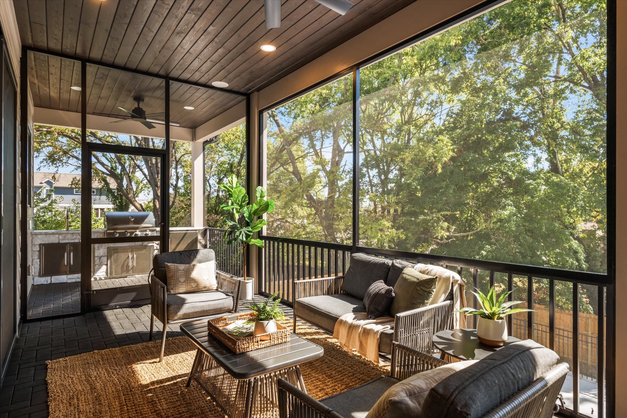 Screened porch with a wood ceiling, a gas fireplace, and lounge seating at 817 Horner Ave in 12 South Nashville