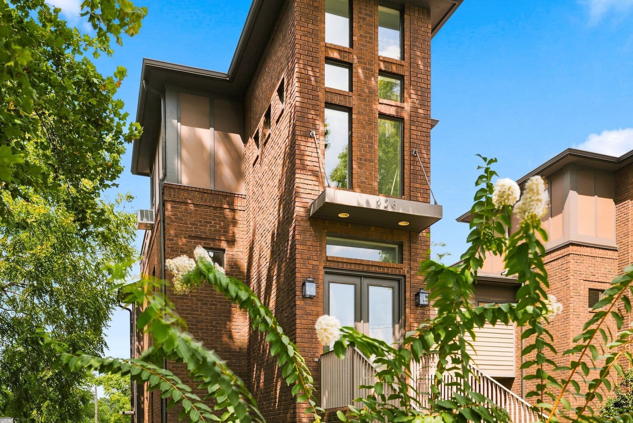 Front exterior of the brick brownstone at 928 Caruthers Avenue, one of the 12 South homes for sale in Nashville