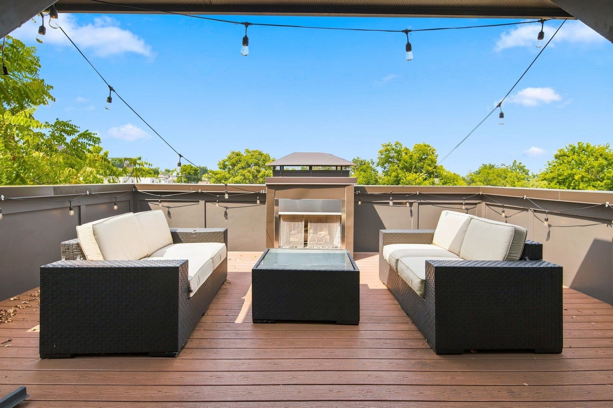 Rooftop deck with seating, string lights, and fireplace at 928 Caruthers Avenue near 12 South Nashville