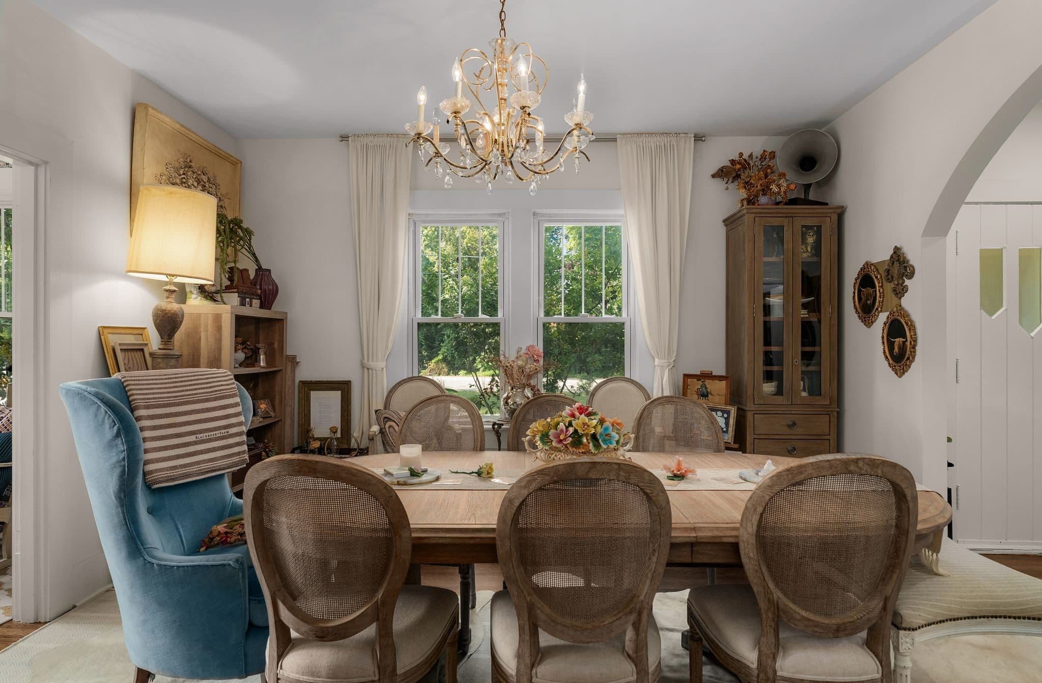 Dining room with a chandelier, a long wood table and a pair of windows at 947 Gale Lane in 12 South Nashville