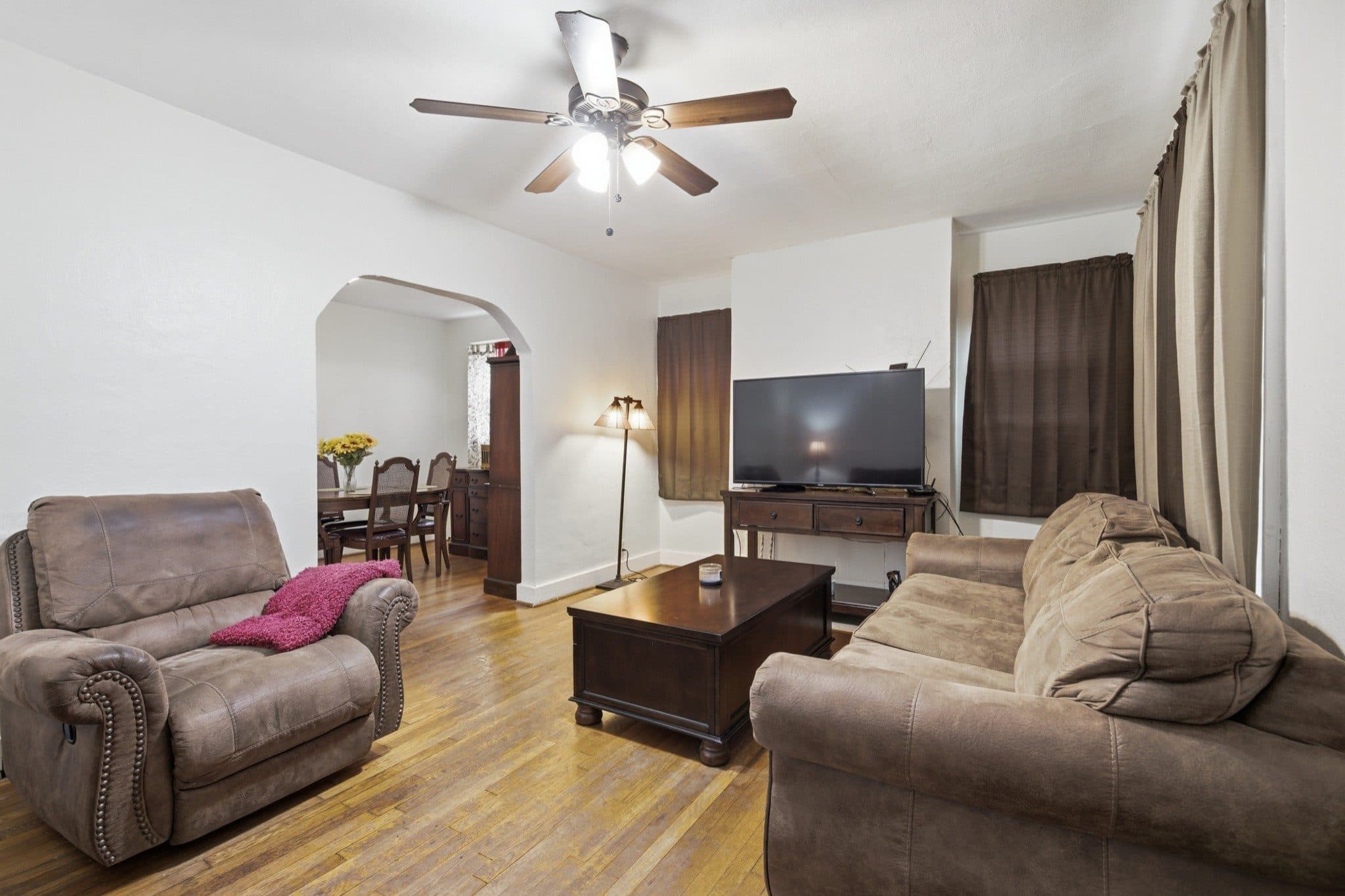 Living room with hardwood floors and an arched opening to the dining room at 2305 Cisco Street, 12 South Nashville