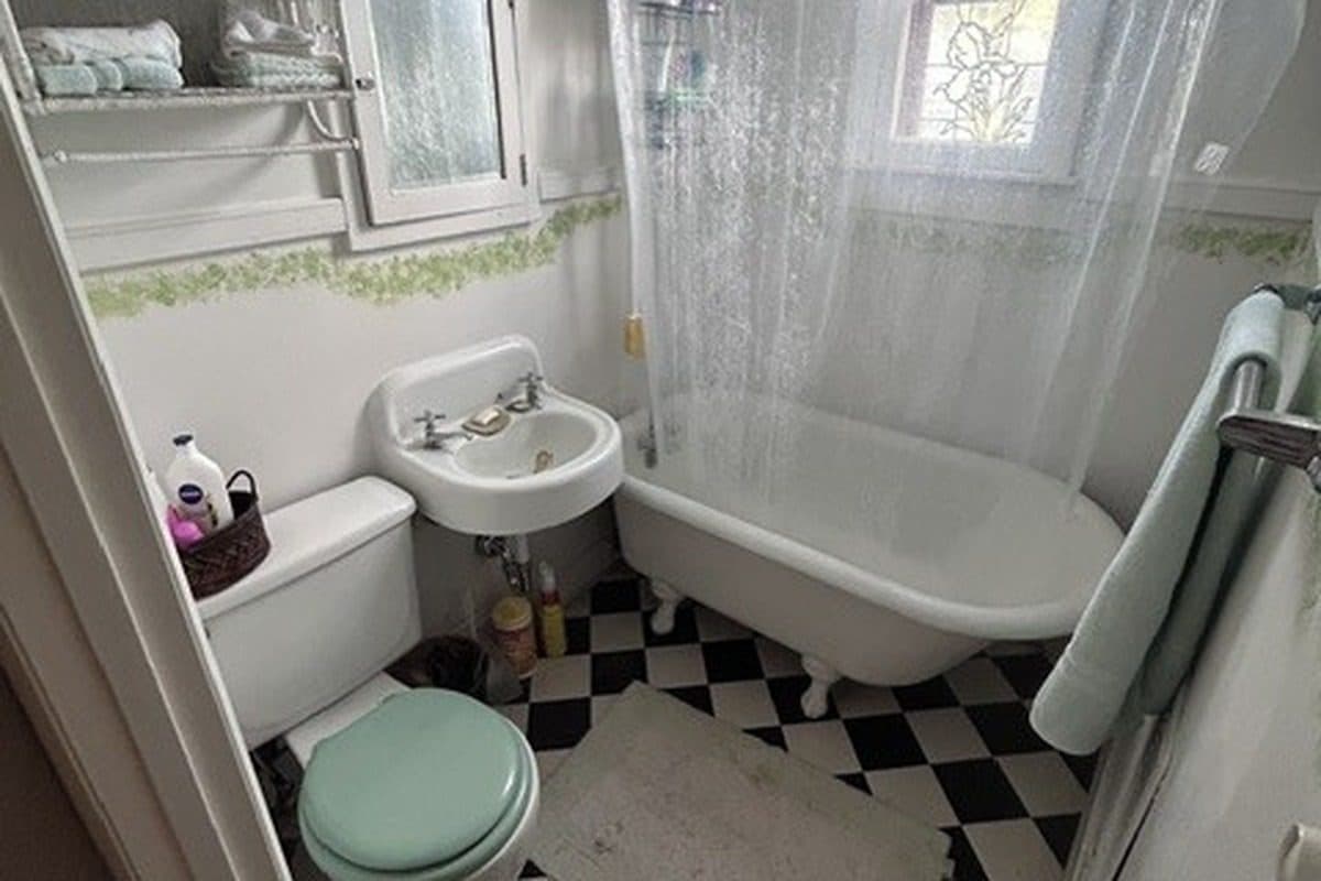 Upstairs bath with a claw-foot tub and black and white tile floor at 2207 Elliott Avenue, 12 South Nashville