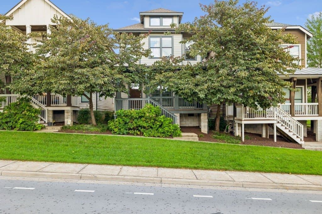 Front exterior of 143 Gale Park Lane with its porch, trees, and lawn, one of the 12 South homes for sale in 12 South Nashville