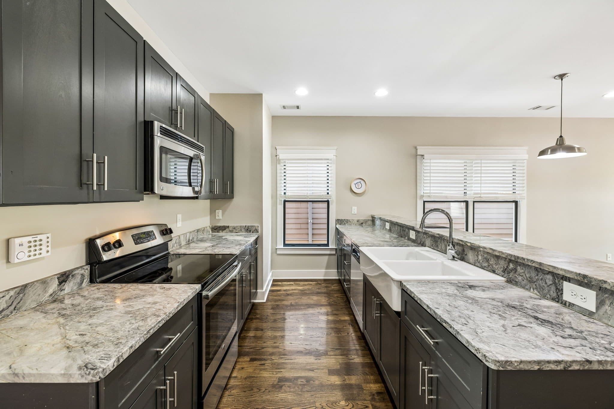 Kitchen with granite counters, dark cabinets, and a farmhouse sink at 143 Gale Park Lane, 12 South Nashville