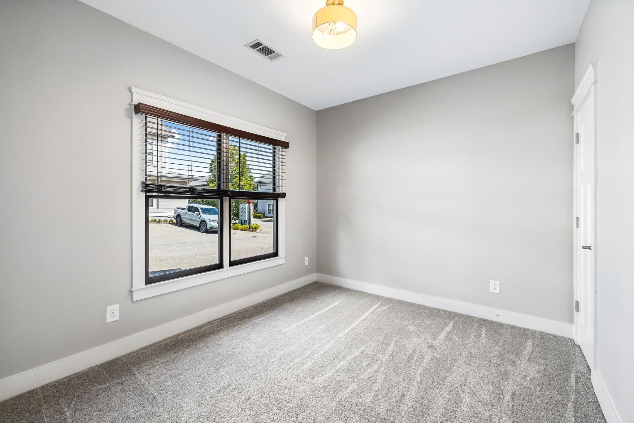 Downstairs bedroom or office with a large window and gray carpet at 143 Gale Park Lane, 12 South Nashville
