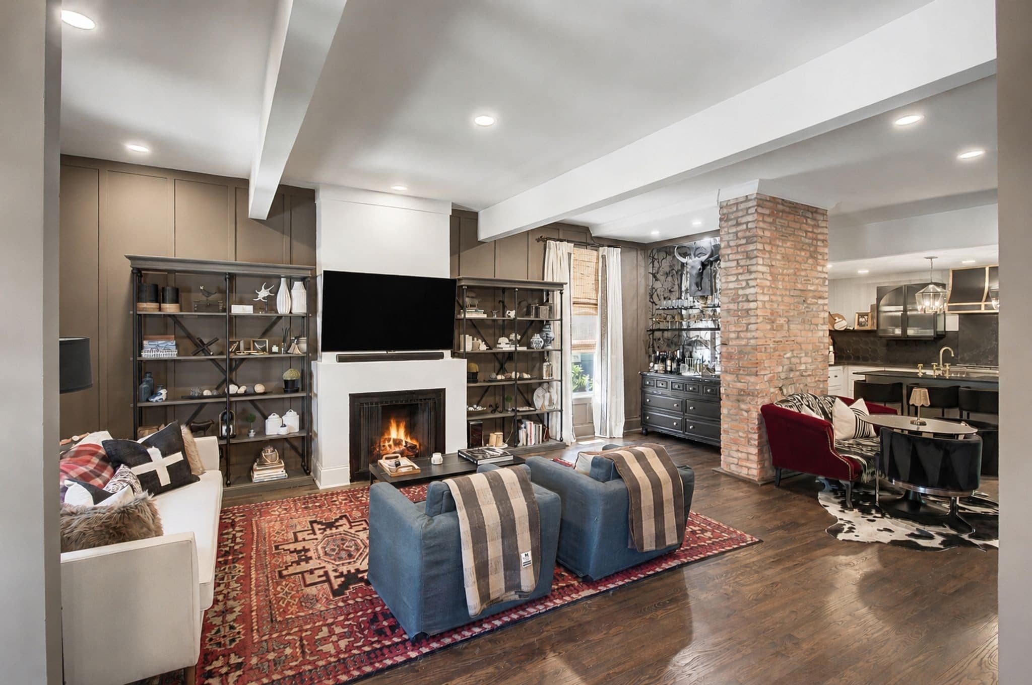 Living room with a fireplace, exposed brick column, and hardwood floors at 837 Glen Avenue, 12 South Nashville