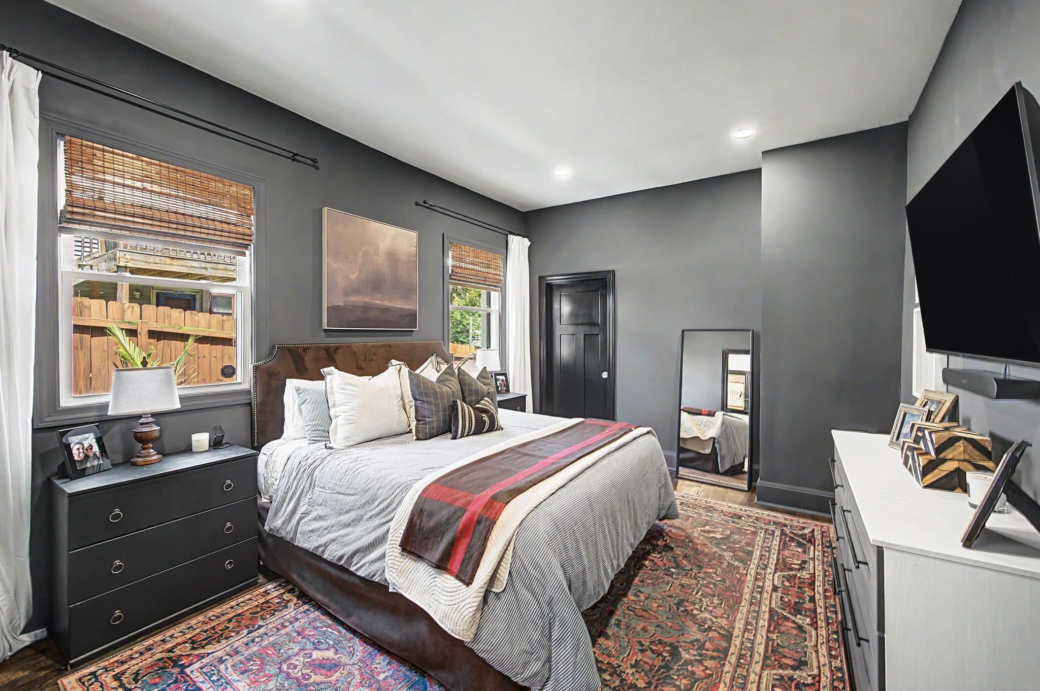 Main floor primary bedroom with dark walls and hardwood floors at 837 Glen Avenue, 12 South Nashville