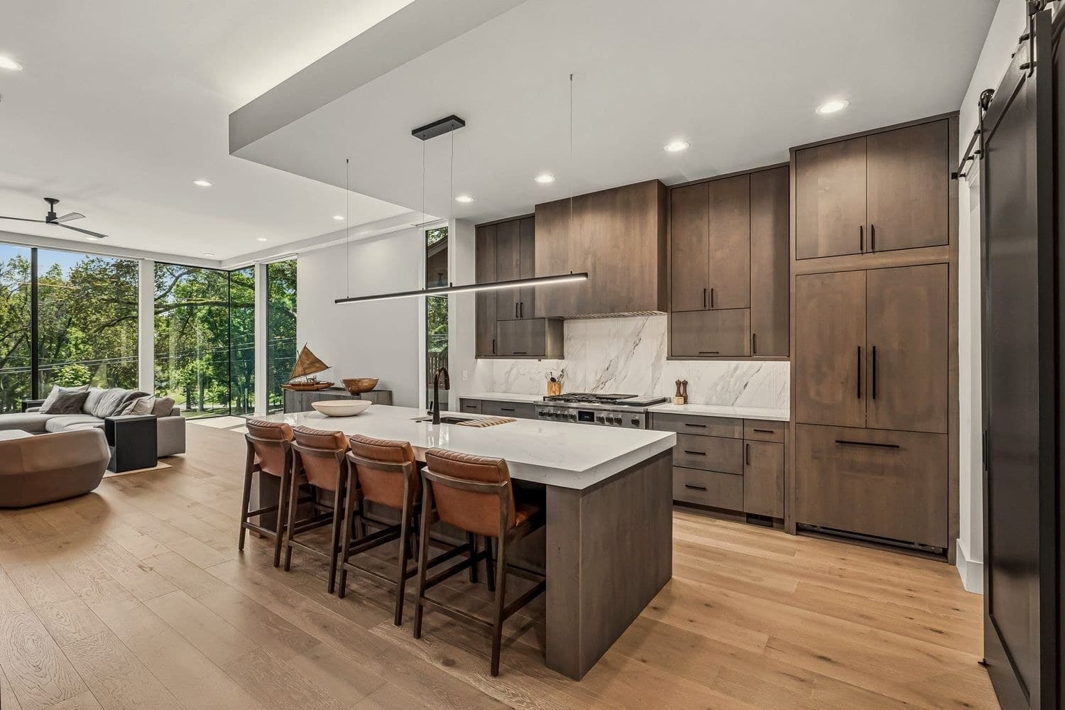 Modern kitchen with large island, bar seating, and integrated appliances at 3205B Granny White Pike, 12 South Nashville