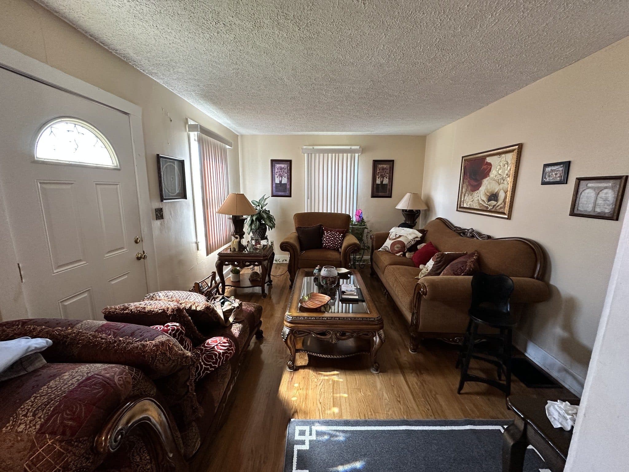 Living room with hardwood floors and an arched-window front door at 820 Horner Avenue, 12 South Nashville
