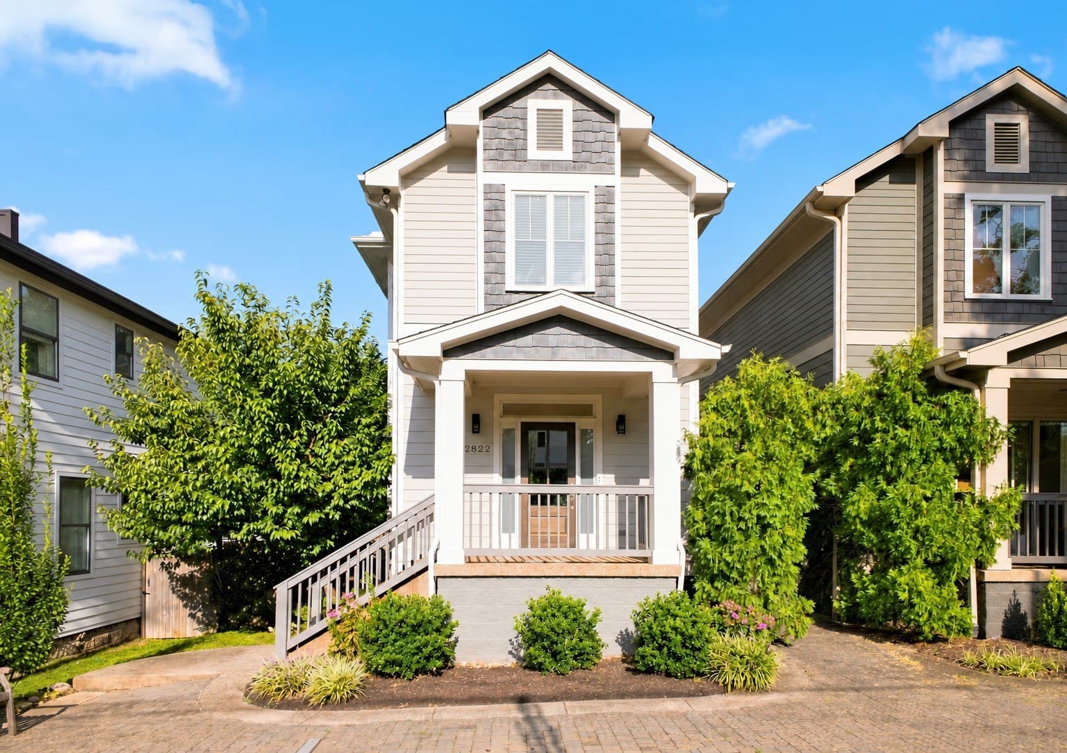 Front exterior of the light gray cottage with covered porch and house number 2822 at 2822 W Kirkwood Avenue, one of the 12 South homes for sale in 12 South Nashville