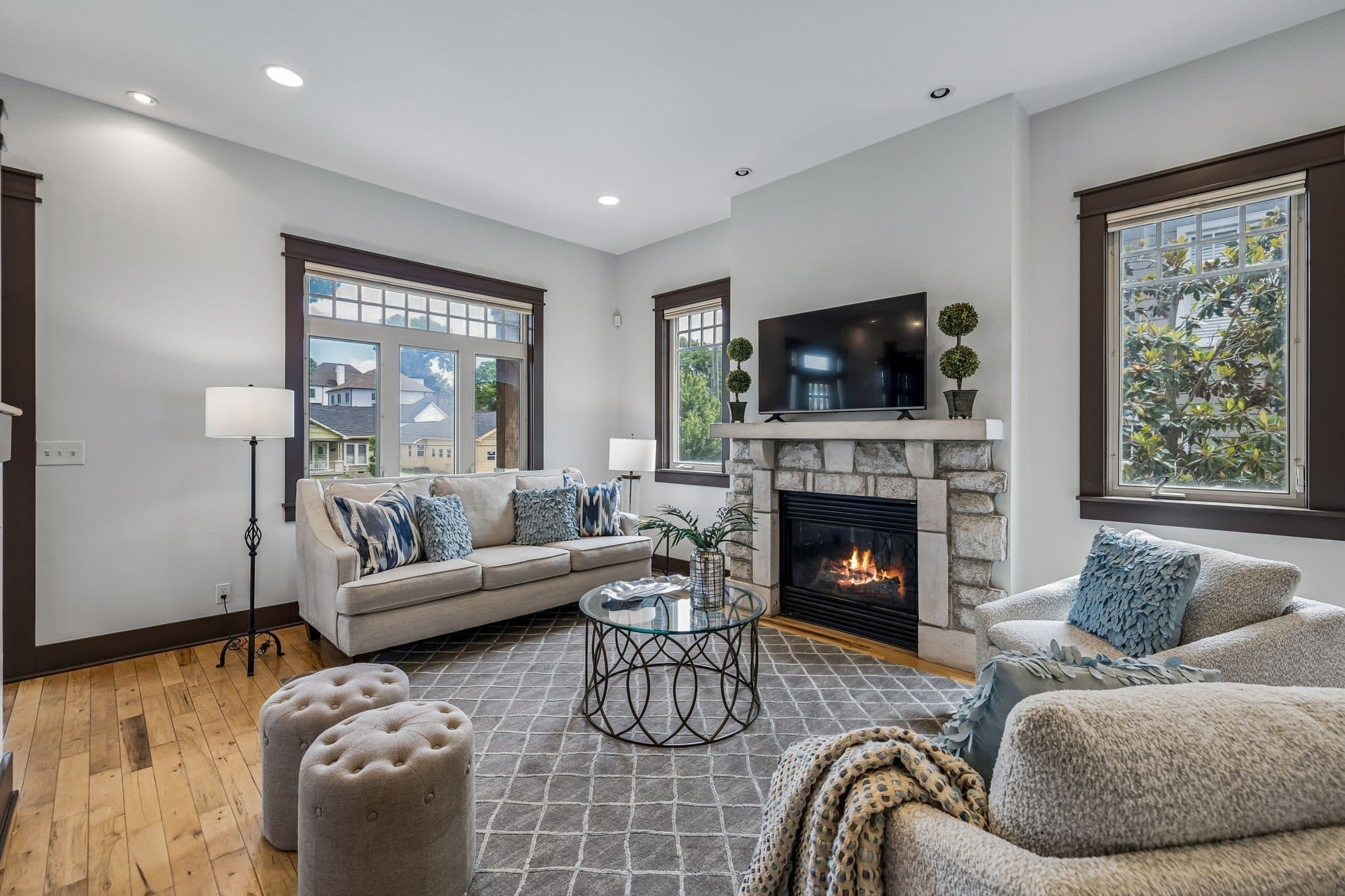 Living room with a stone gas fireplace and hardwood floors at 925 Wedgewood Avenue, 12 South Nashville